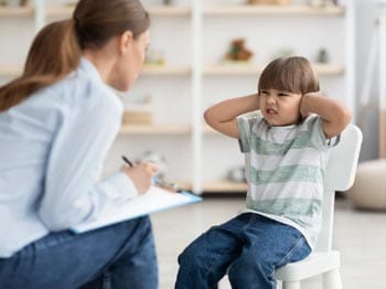 Behaviour support practitioner working with a child displaying resistance
